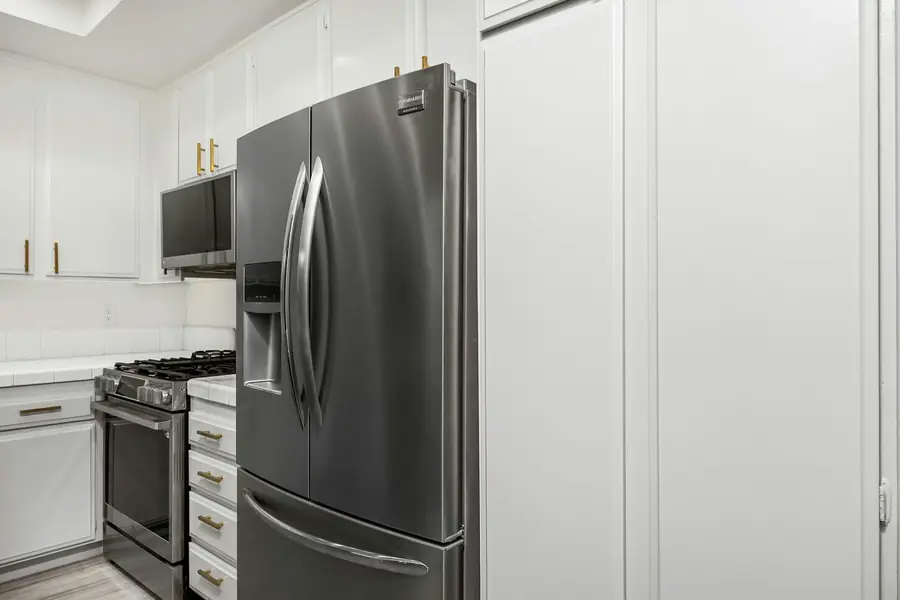 Stainless steel refrigerator in a white kitchen