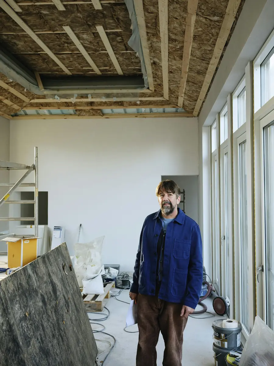 Contractor standing in a room under renovation