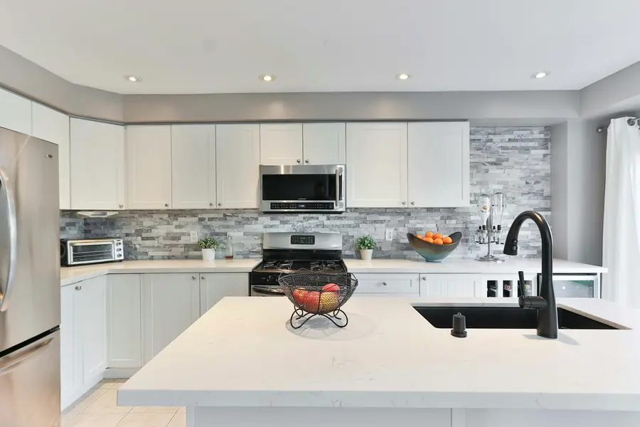 Stainless steel French door refrigerator in a white kitchen