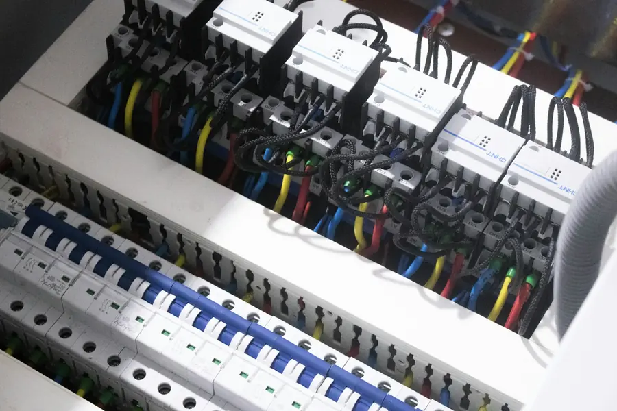 Rows of circuit breakers inside an open electrical panel