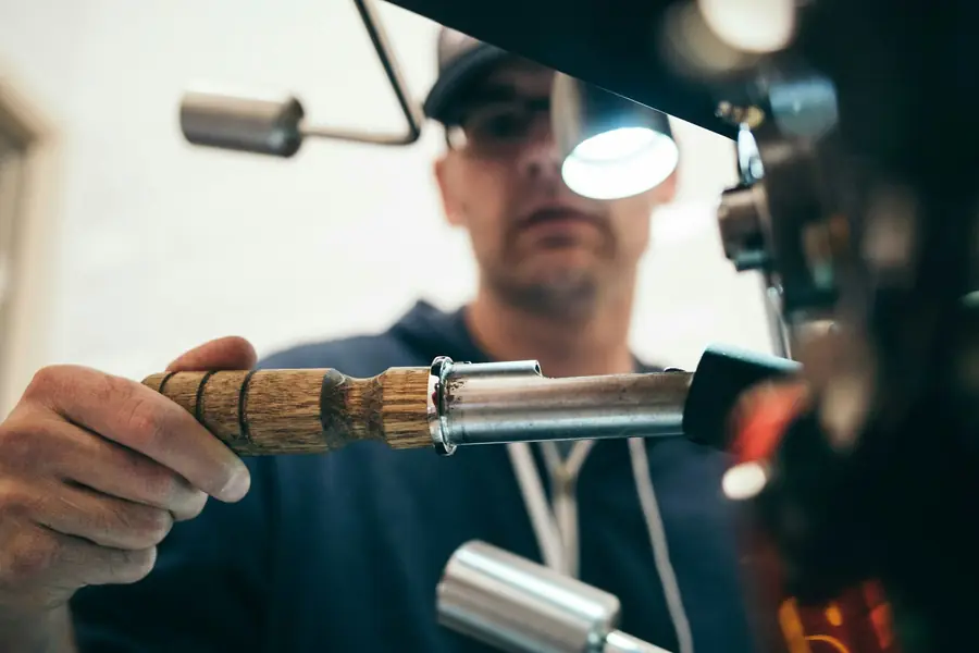 Technician using a lit inspection tool on electrical equipment